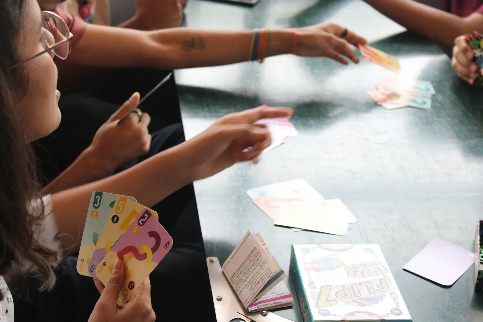 Players sharing a card game around a café table